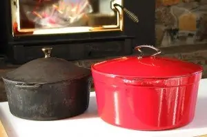 black cast iron pot and red enameled cast iron pot