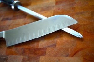 sharp knife laying on sharpener