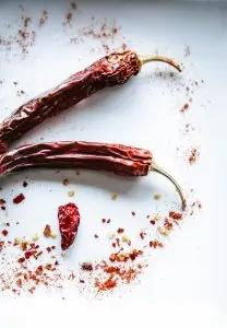 two dried red hot peppers