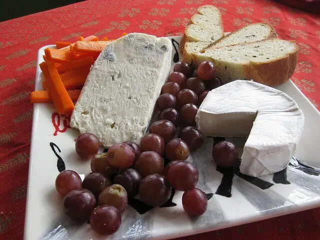 Simple addtions like grapes and carrots make the cheese board interesting and attractive. 