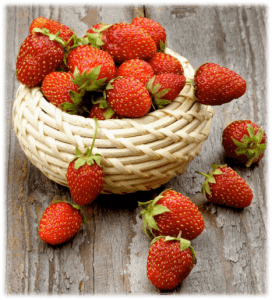 A small basket full of fresh strawberries
