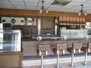 An Empty Howard Johnson Diner Counter with Barstools and Coffee Mugs