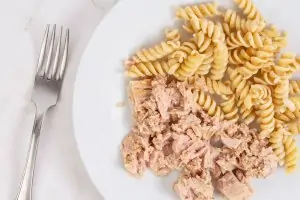 tuna and pasta on white plate with fork