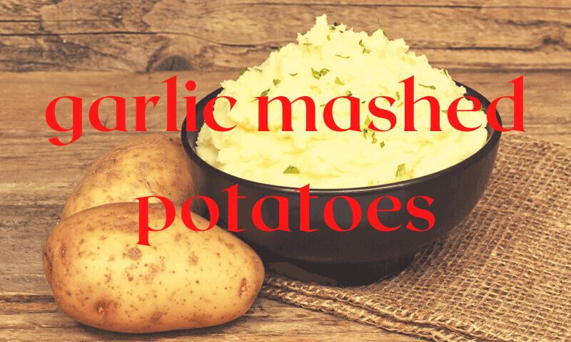 bowl of mashed potatoes with raw potatoes beside bowl