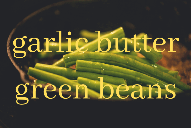 garlic butter green beans in black bowl