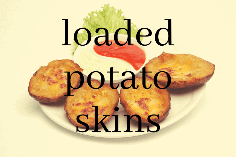 loaded potato skins on plate with dip 