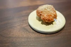 breaded fried chicken oyster on white plate on table