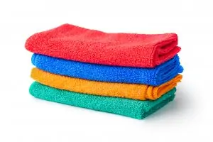 four colorful microfiber cloths on white background