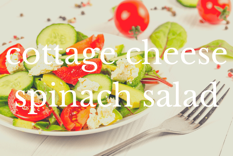 cottage cheese spinach salad in white bowl with fork on white tablecloth