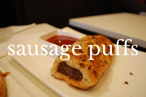 sausage puff on white dish with dip