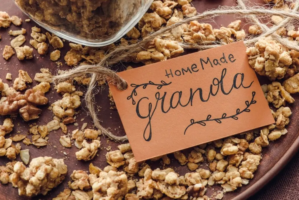 close up of granola on wood table with card that says homemade granola