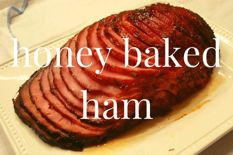sliced honey baked ham on white platter