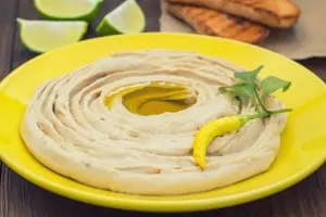 yellow bowl filled with hummus