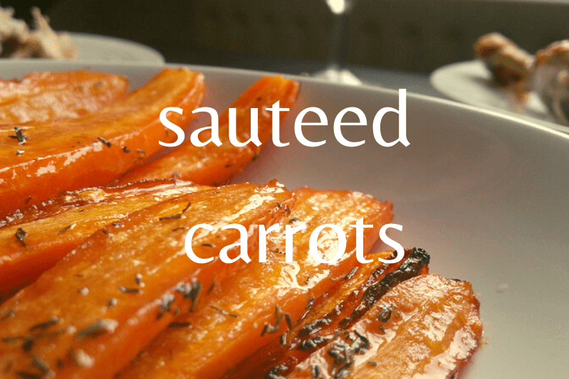 close up of sliced cooked carrots on white dish