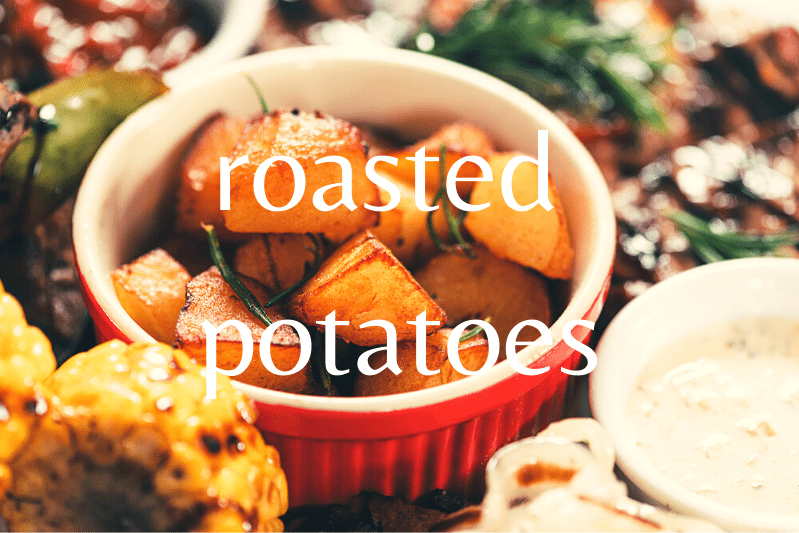roasted potatoes in ramekin surrounded by other foods