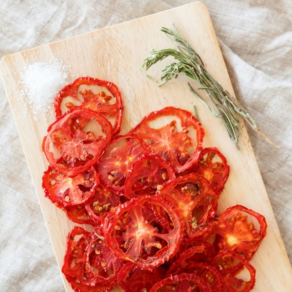 dehydrated tomatoes on a wooden cutting board