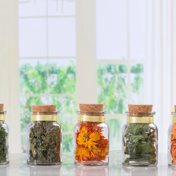 dried herbs and spices in glass jars
