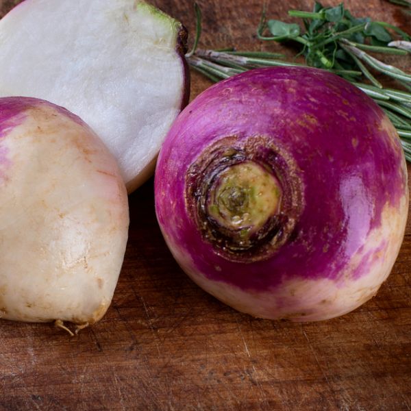 fresh turnips on wooden board