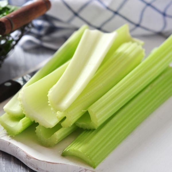 stalks of celery on a chopping board