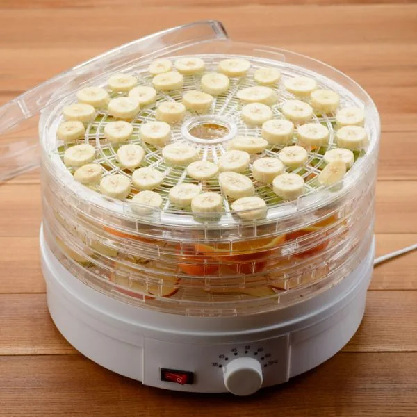 bananas and various fruit in a multi-rack electric dehydrator