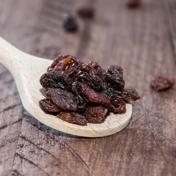 raisins on a wooden spoon