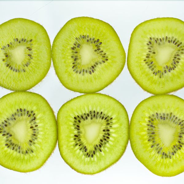 six slices of kiwi on a white background
