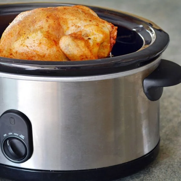 A whole roasted chicken in a slow cooker