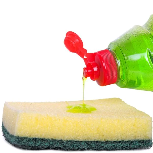 Dishwashing soap being poured onto a sponge