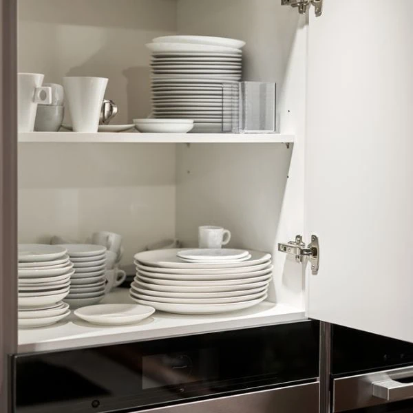 Plates and bowls and other items in a cupboard