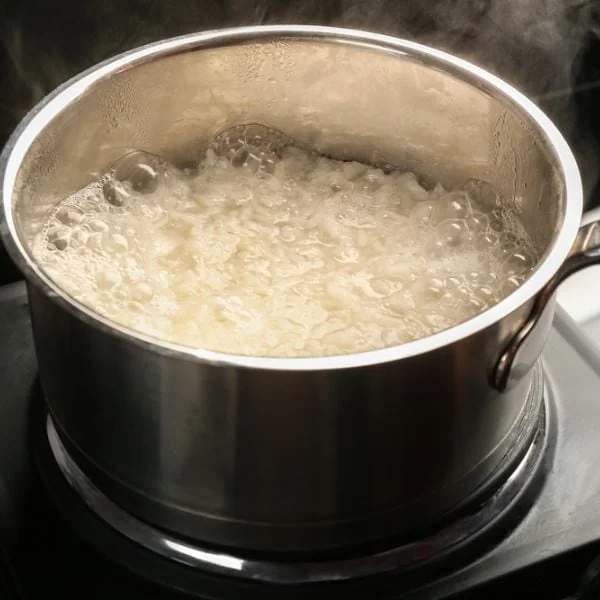 Rice being boiled in a metal pot