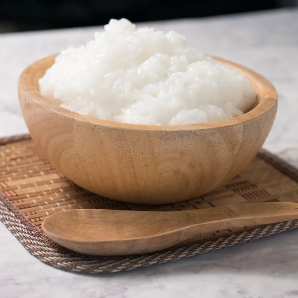 Very wet rice in a wooden bowl