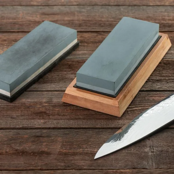 Two knife sharpeners on a wooden surface