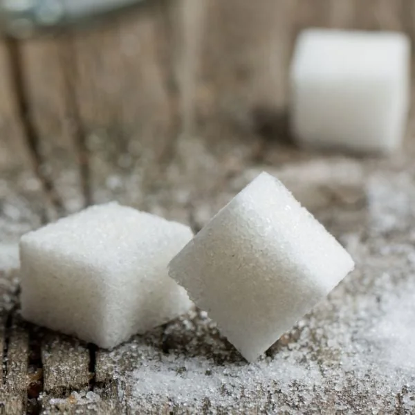 Cubes of sugar on a wooden surface