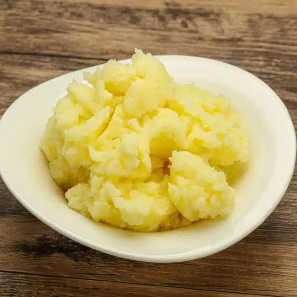 A small amount of mashed potatoes in a small white bowl