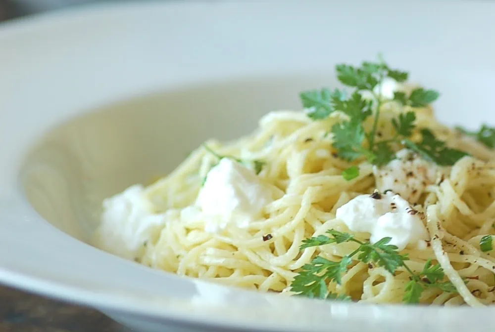 Angel hair pasta in a white bowl