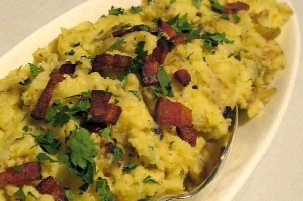 Bacon mashed potatoes in a white oval bowl