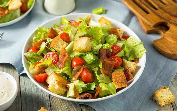 Bacon and tomato salad in a white bowl