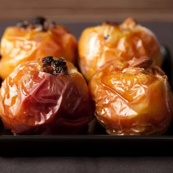 Delicious baked apples on a black plate