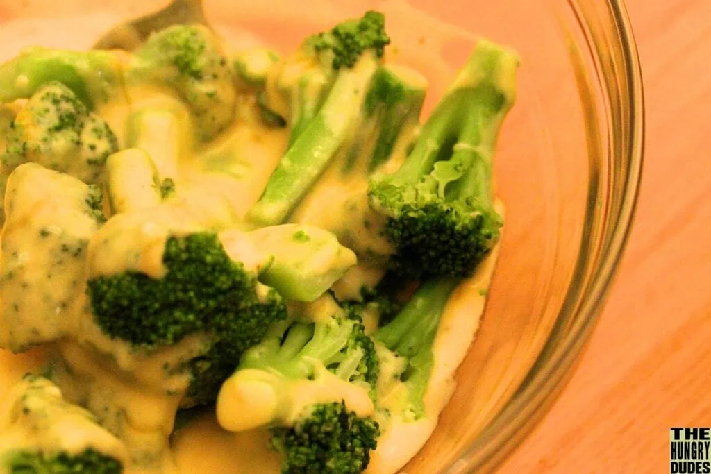 Cheesy broccoli in a clear bowl
