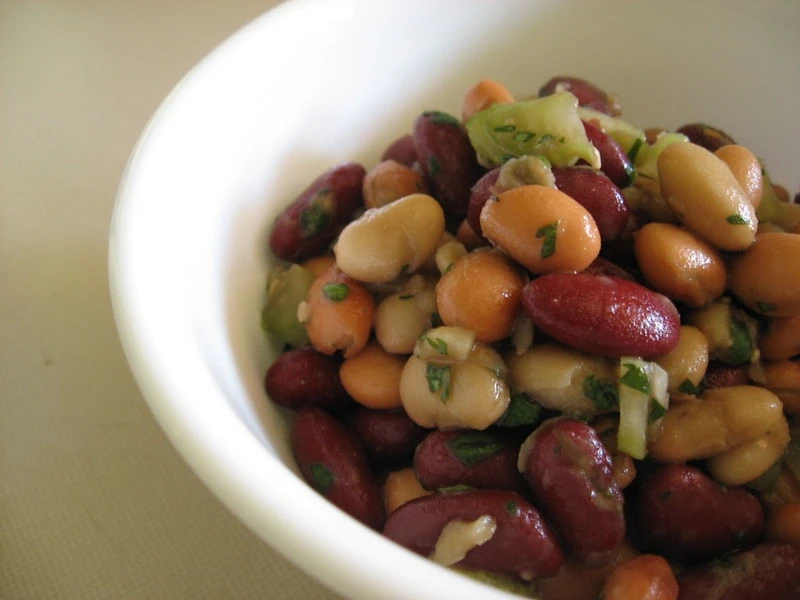 Three bean salad in a white bowl