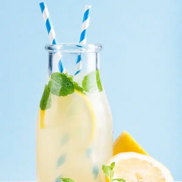 Lemonade in a bottle with blue straws