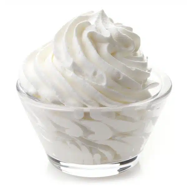 Whipped cream in a glass bowl on a white background